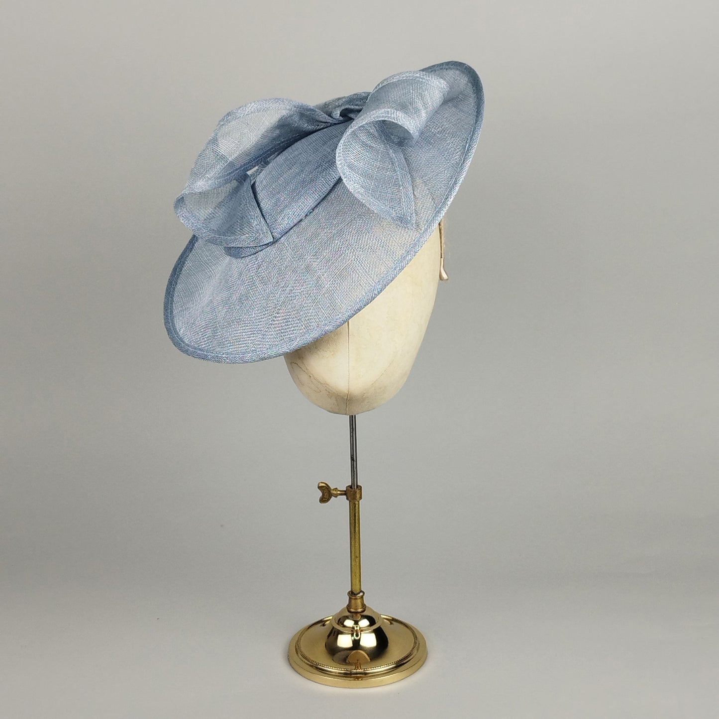 Pale blue wedding hat with sculptural sinamay swirls