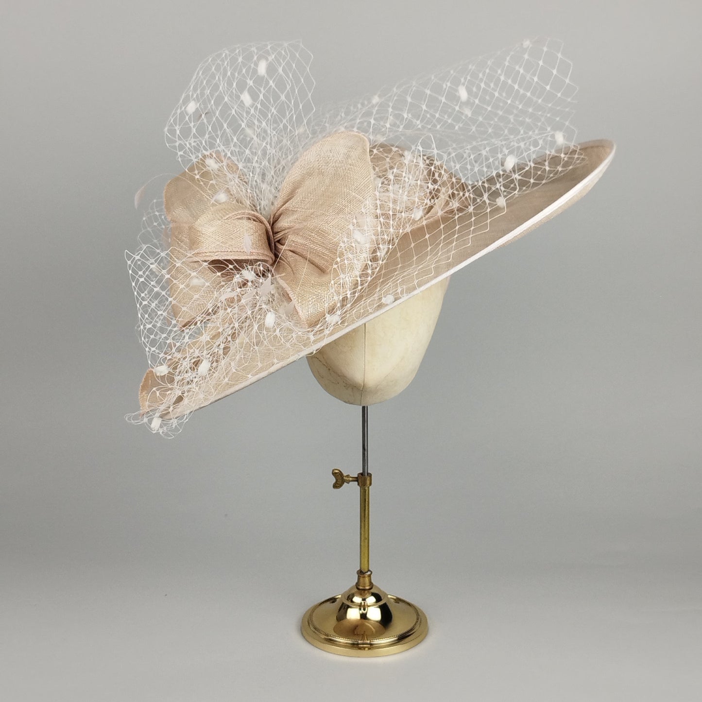 Cream wide brim wedding hat with birdcage veiling decoration