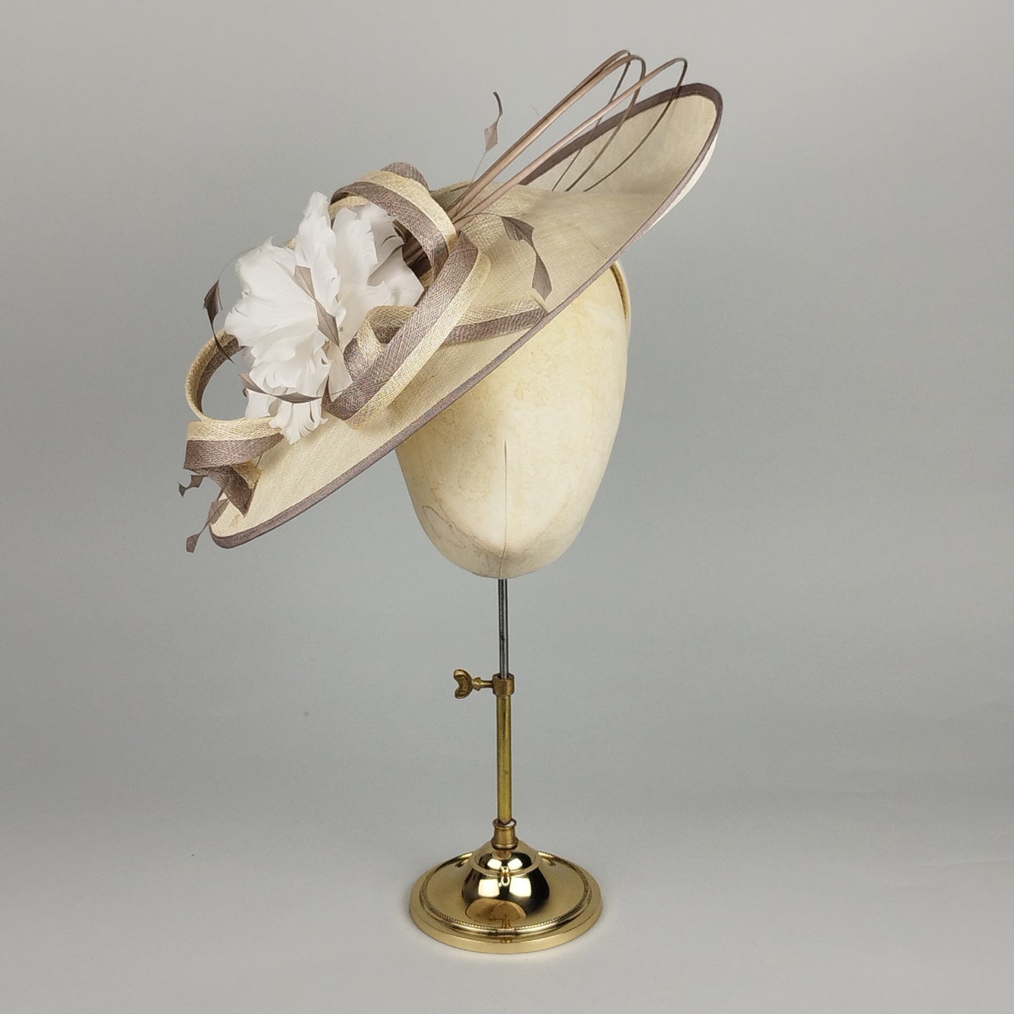 Two-tone mocha and cream hatinator with feather flower and sculptural swirls