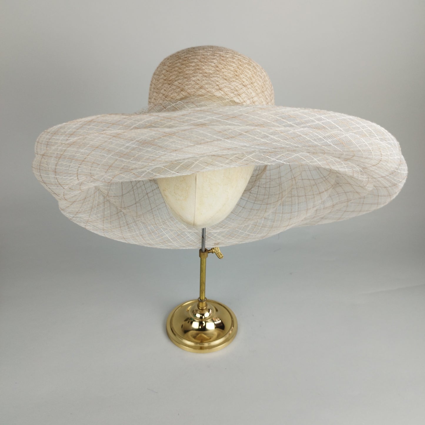Floppy crinoline hat styled to resemble straw, perfect for casual and formal events. Versatile and chic.