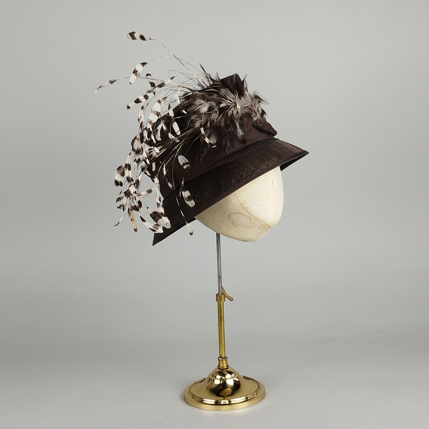 Chocolate brown ladies formal hat with feather accent, perfect for weddings and formal occasions.