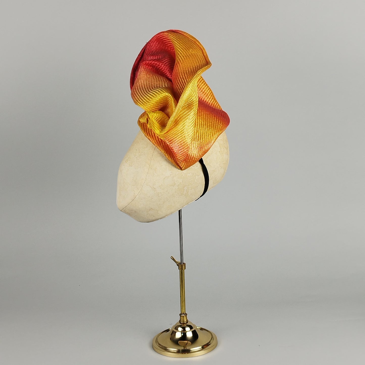 Orange ombré headpiece with golden yellow accents, perfect for weddings, Royal Ascot, and bold events.