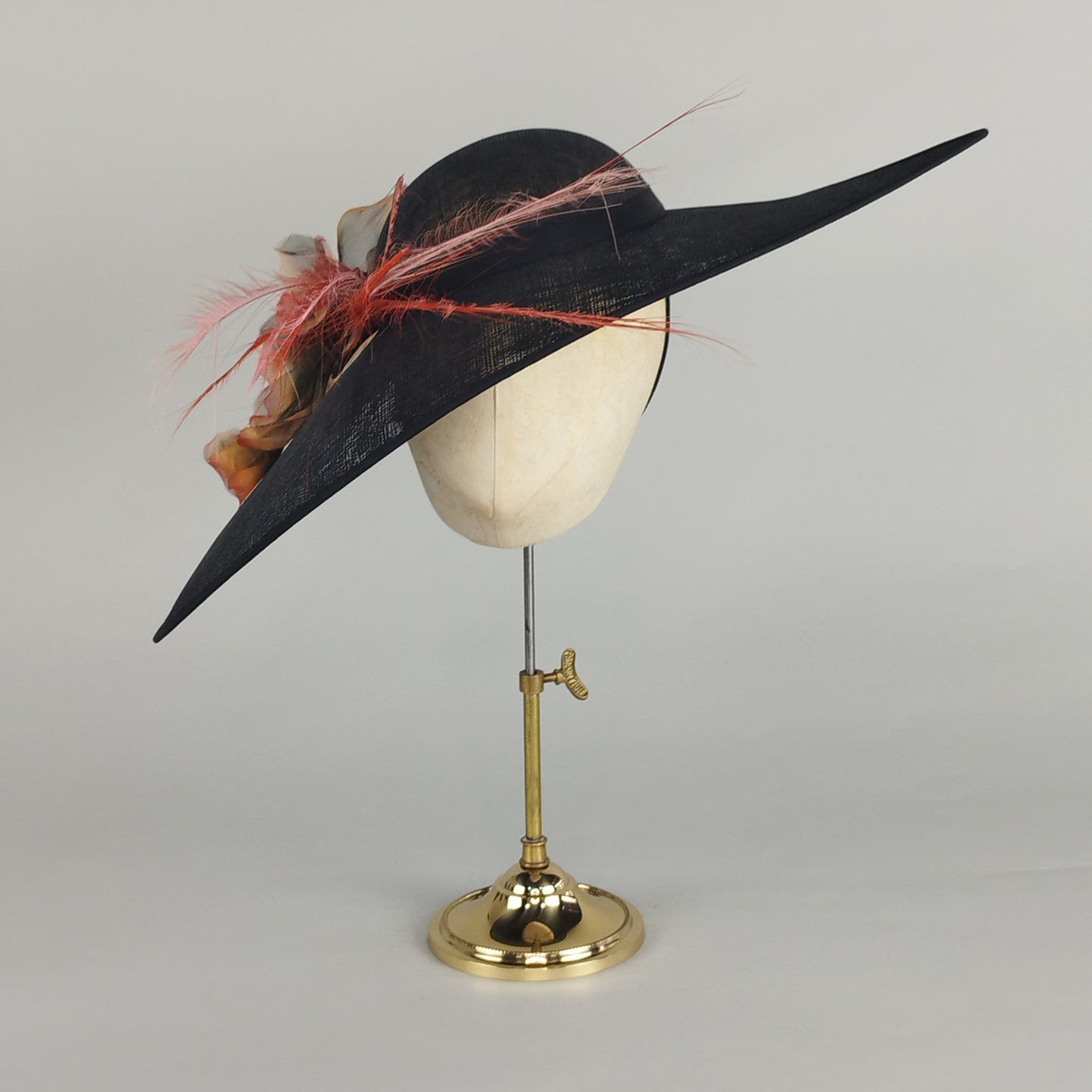 Black sloped hat with pink and orange feathers and a vintage chiffon flower in burnt orange, perfect for Royal Ascot or weddings.