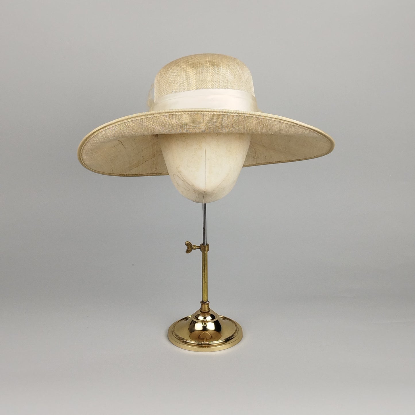 Cream summer cloche hat with structured ivory bow detail for weddings and special occasions