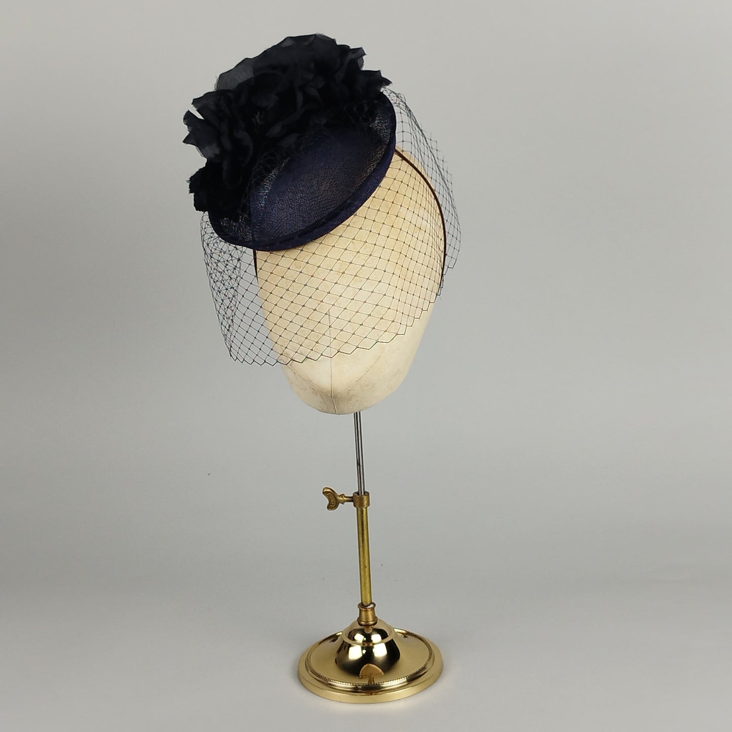 Navy fascinator with silk and organza rose and birdcage veil, perfect for weddings and Royal Ascot