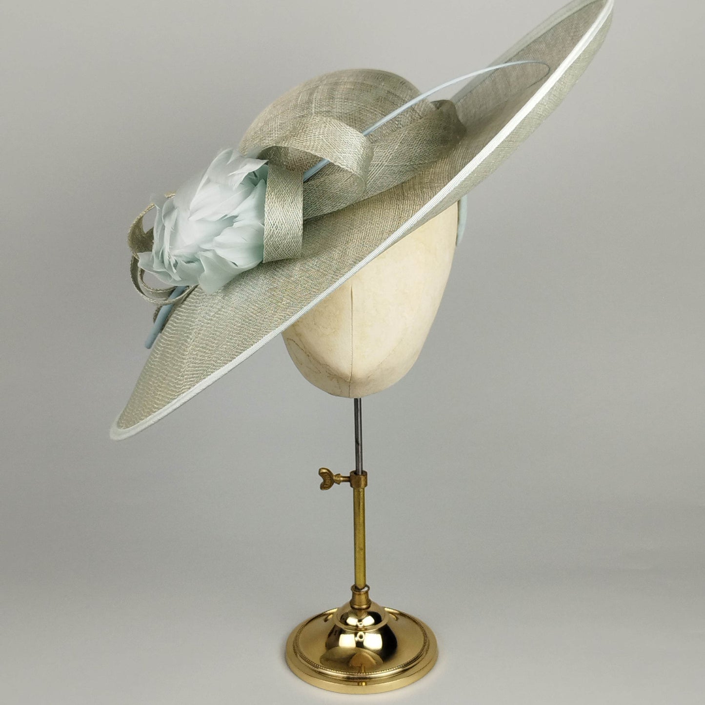 Mint green fascinator with feather flower and quill, perfect for weddings, race days, and special occasions.
