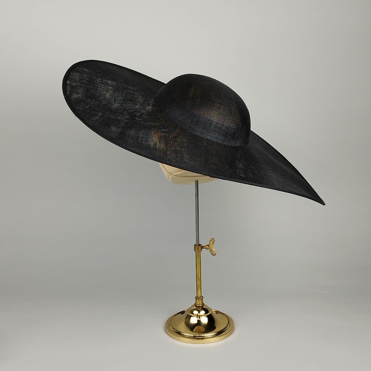Minimal black wide brim hat with subtle upward sweep