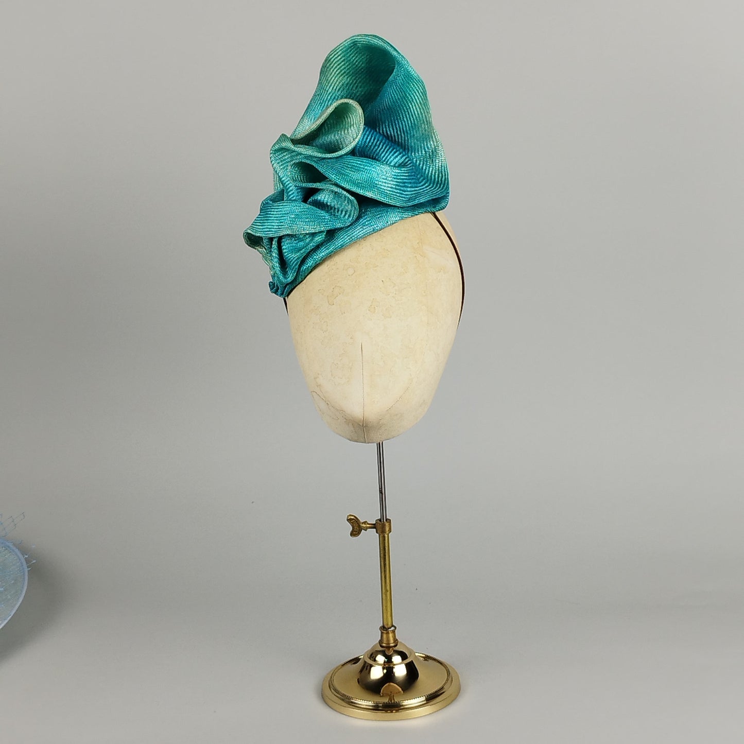 Organic turquoise straw headpiece, hand-dyed to resemble ocean waves, perfect for weddings and special occasions.