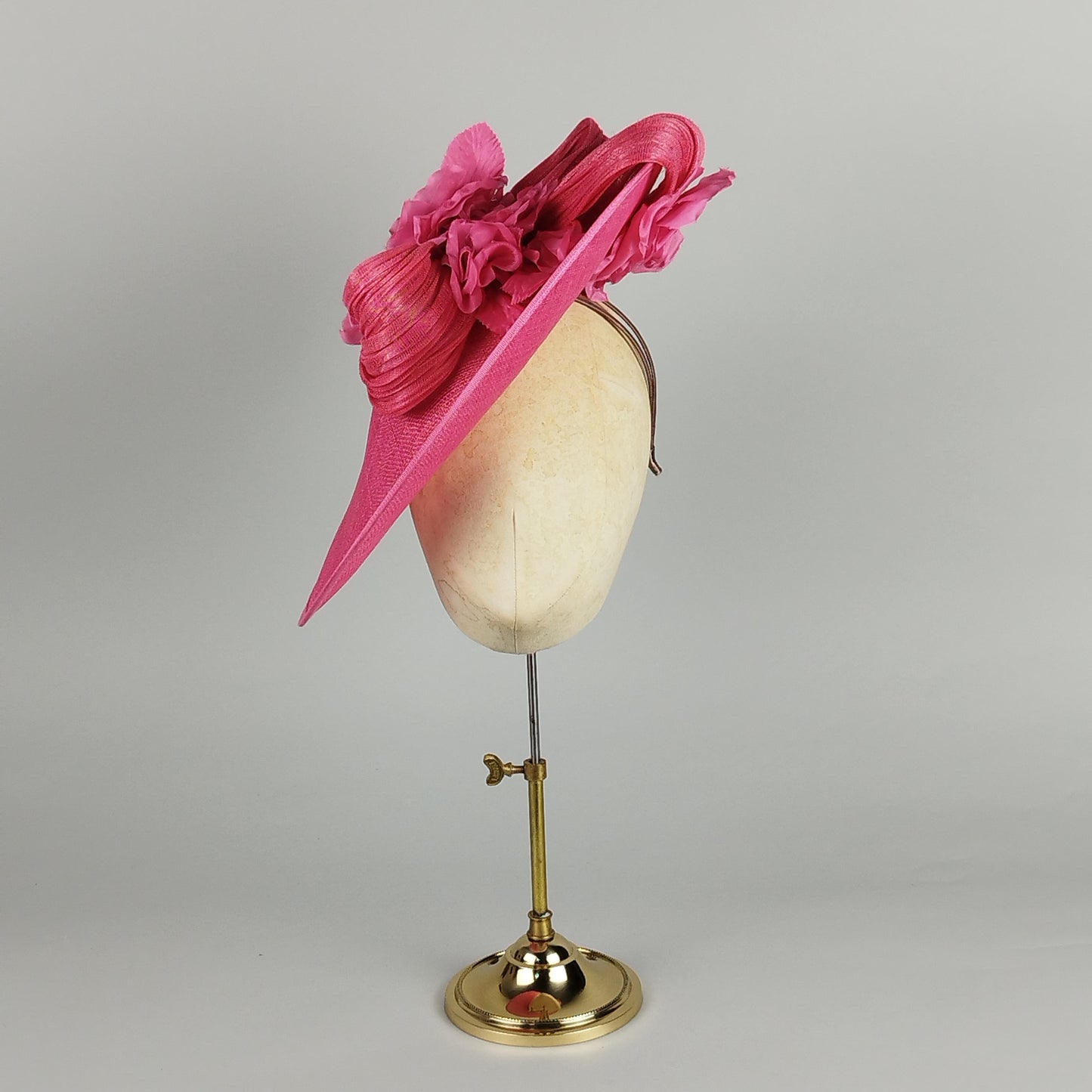 Hot pink hatinator with sculptural swirls and floral detail - contemporary wedding guest hat design