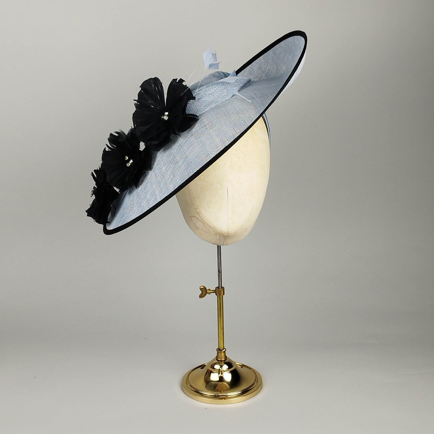 Cornflower blue fascinator with black feather flowers