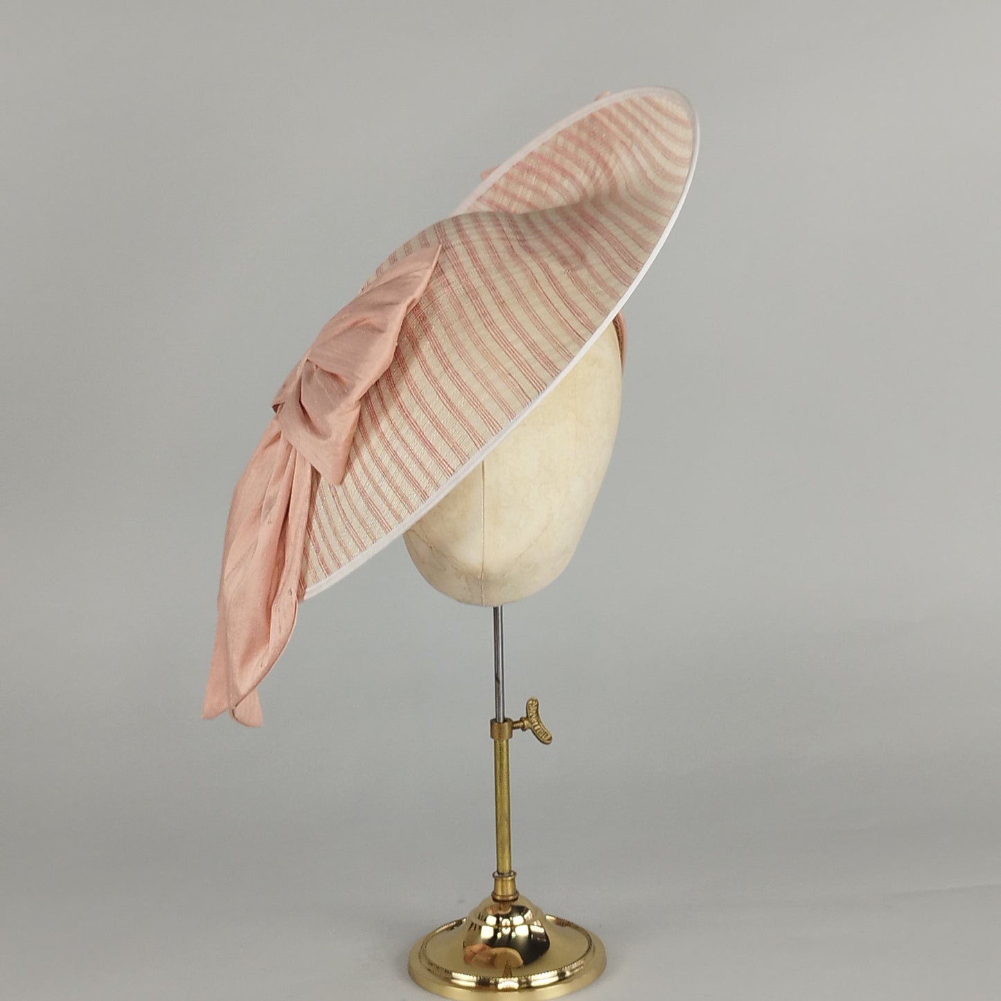 Large ivory hatinator with coral pink stripes and apricot silk bows, perfect for Bridgerton-inspired weddings or garden parties.