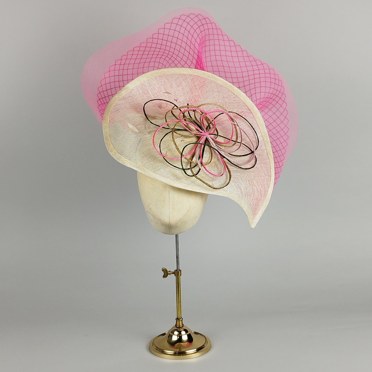 Multicoloured large fascinator with diamond crinoline spray, mounted on a neutral teardrop base. Bold and fun statement piece.