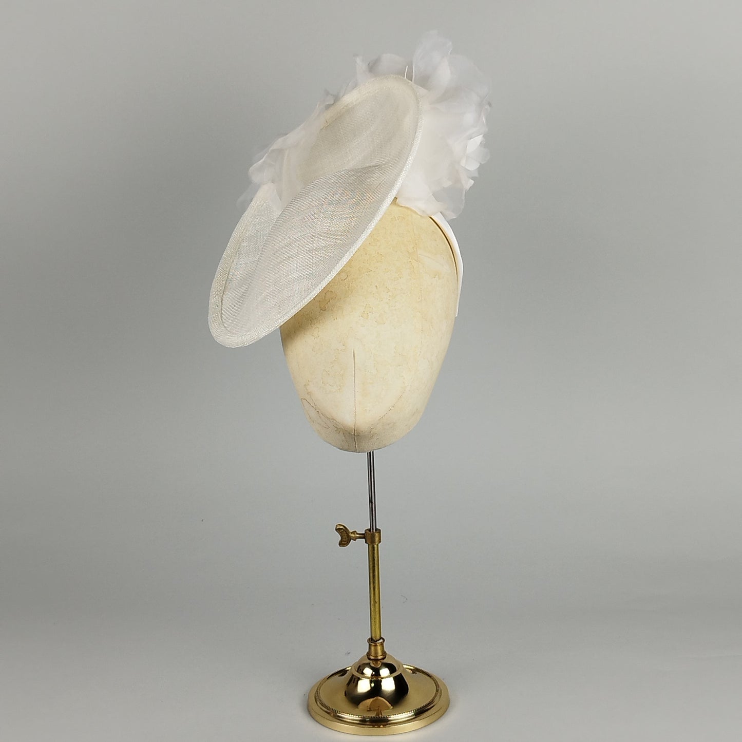 White saucer fascinator with two large silk and organza flowers. Elegant and romantic for weddings and special occasions.