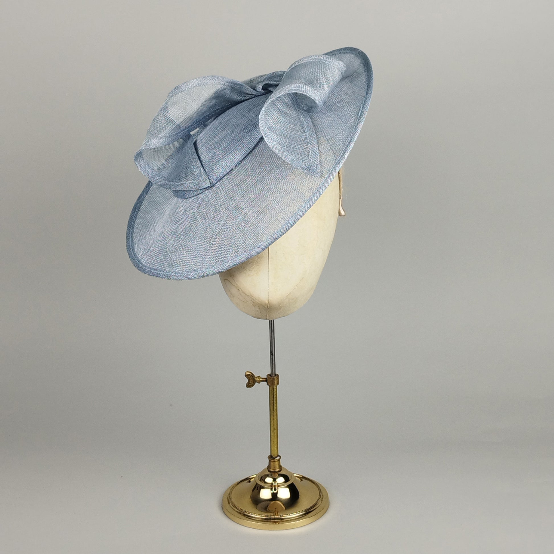 Pale blue wedding hat with sculptural sinamay swirls
