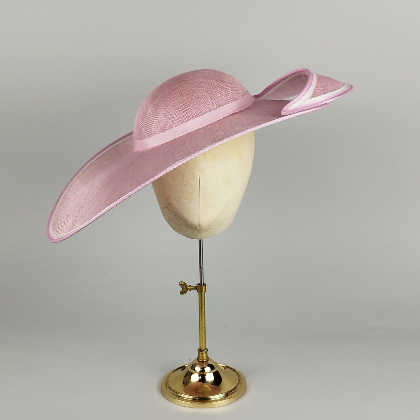 Pale pink hat for wedding with a cut-out brim and ribbon trim, perfect for weddings and Royal Ascot royal enclosure