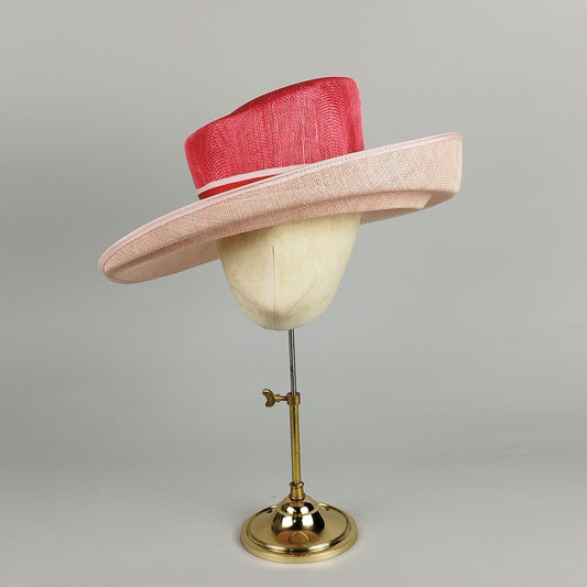 Coral and pink ladies formal hat with groovy curves – modern millinery with a touch of fun.