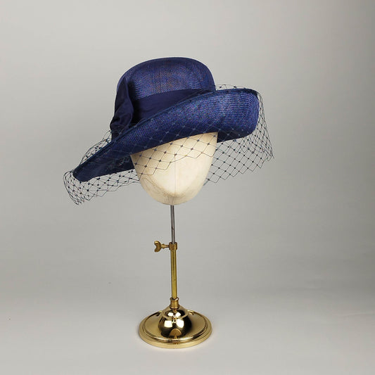 Navy asymmetric cloche hat with birdcage veil and silk bow