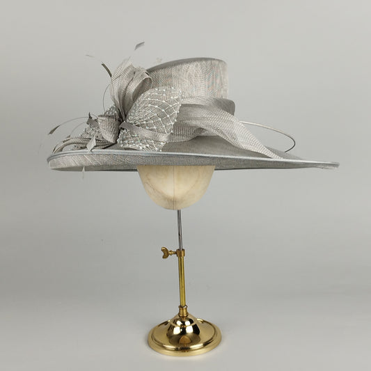 Silver-grey hat with diamante veiling, bow, and feathers for a glamorous look