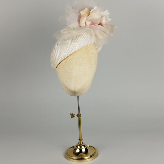 Ivory fascinator with blush oversized flower, perfect for weddings and Royal Ascot, blending structure and romance.