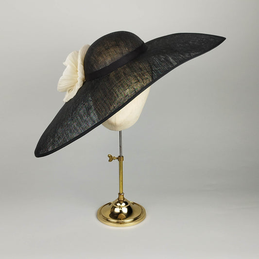 Black asymmetrical wide brim hat with ivory pleated flower detail