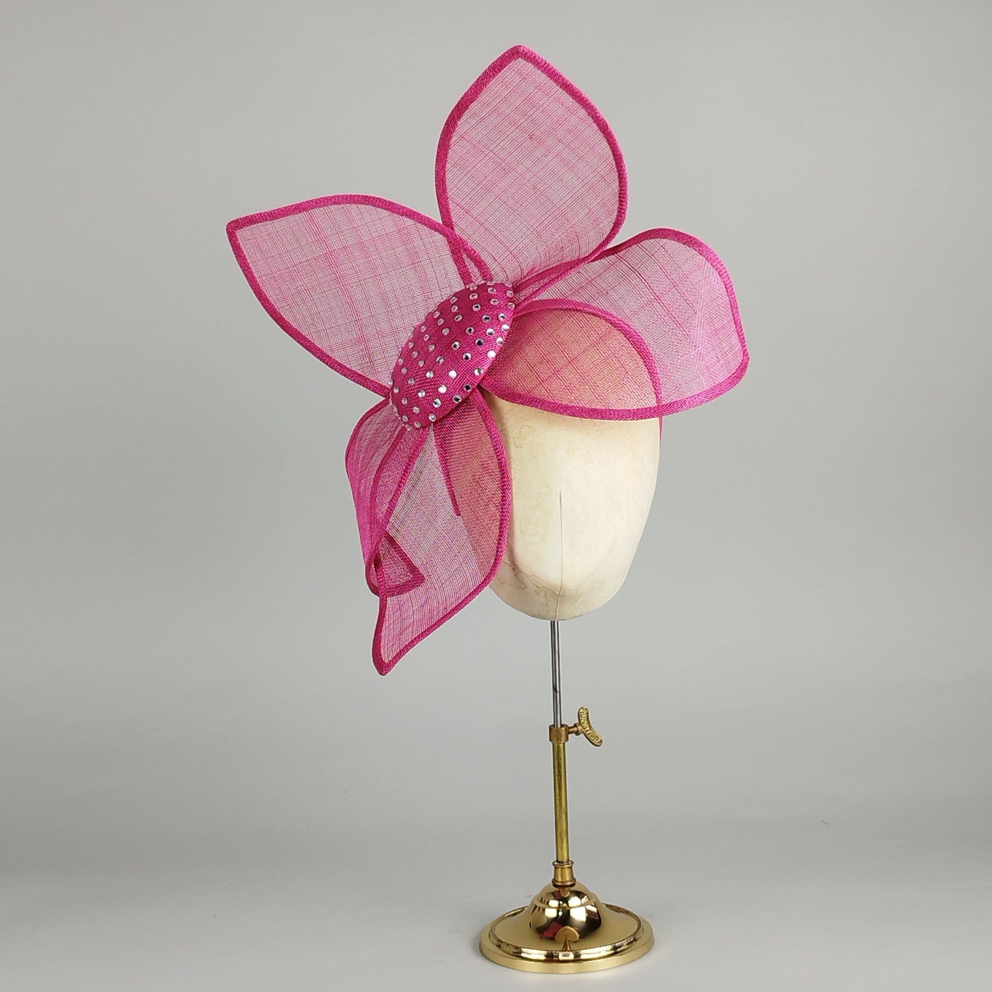 Hot pink fascinator with diamantes and sinamay petals, perfect for weddings and Royal Ascot. Bold, fun, and glamorous.