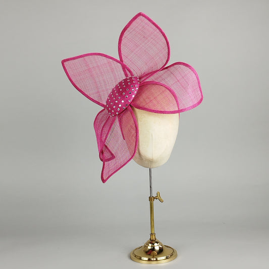 Hot pink fascinator with diamantes and sinamay petals, perfect for weddings and Royal Ascot. Bold, fun, and glamorous.