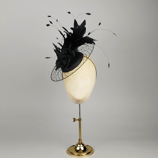 Black pillbox fascinator with dramatic feathers and circular birdcage veil