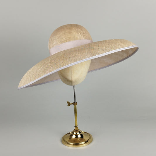 Elegant wide brimmed hat with neutral tones of cream, champagne, and pale grey. Perfect for weddings and Royal Ascot.