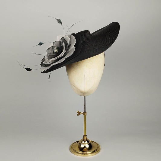 Black vintage-inspired mini boater hat with dramatic black and White flower and feather detail