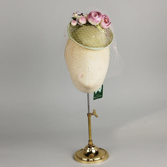 Pastel green fascinator with vintage flowers in ivory and pink, and a vintage veil, perfect for weddings and elegant occasions.