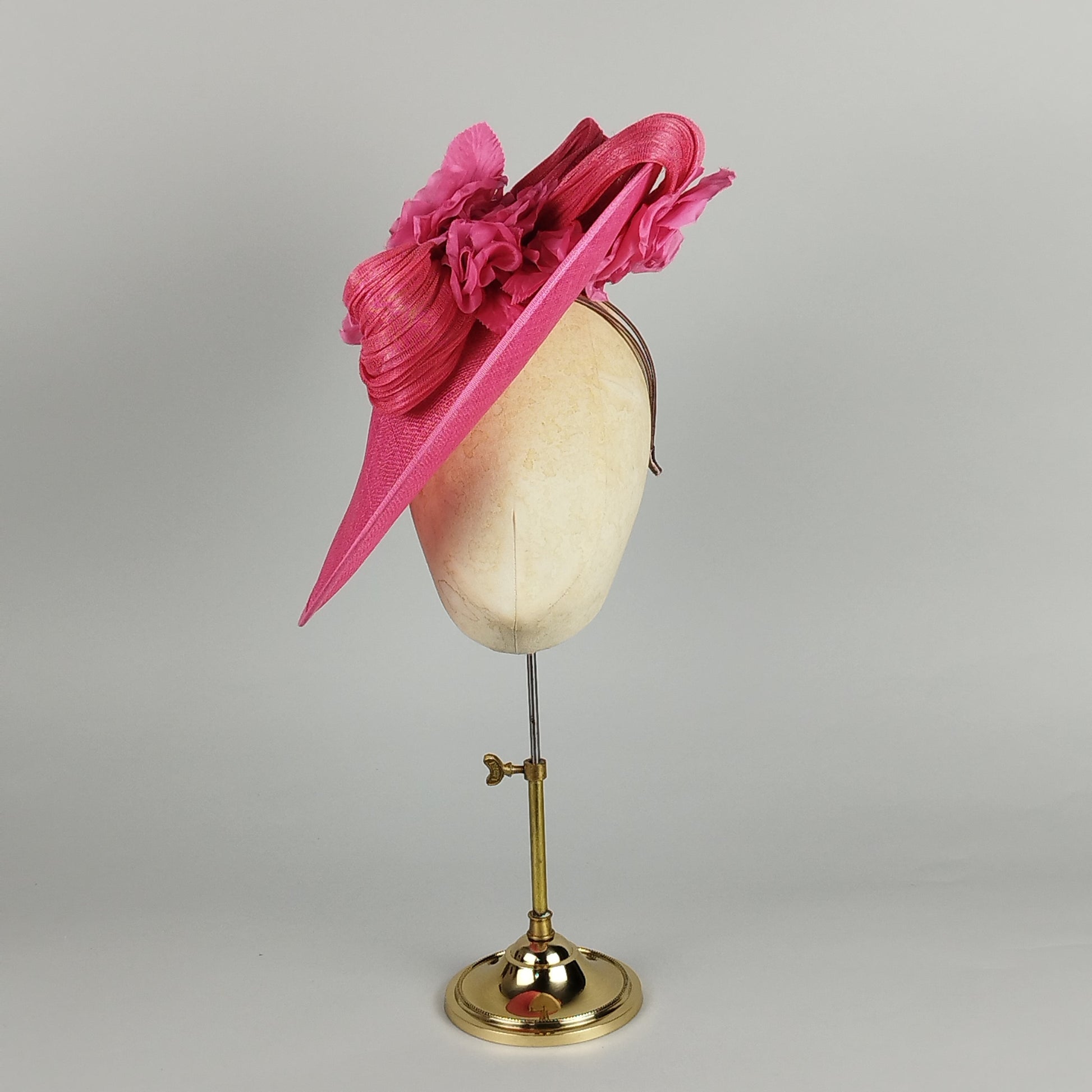 Hot pink hatinator with sculptural swirls and floral detail - contemporary wedding guest hat design