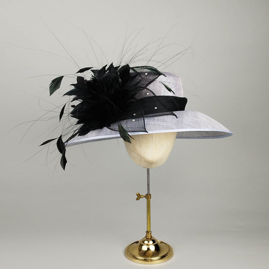 Powder blue formal hat with dramatic black feather spray, sinamay flower, and diamante sparkle—elegant and sophisticated.
