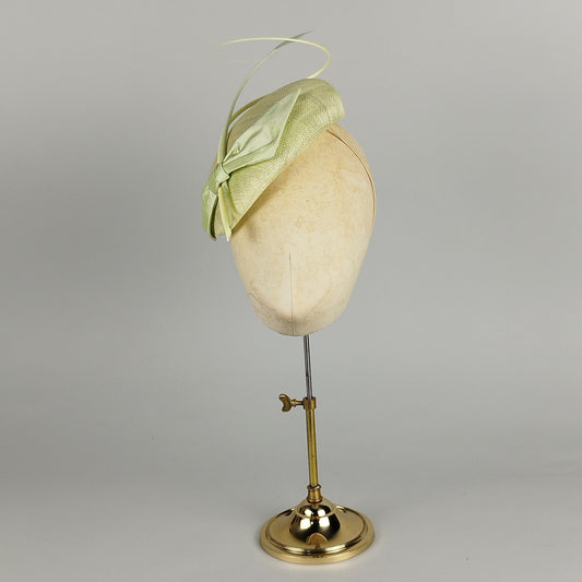 Pastel green fascinator with feather flower and quill, perfect for weddings, race days, and special occasions.