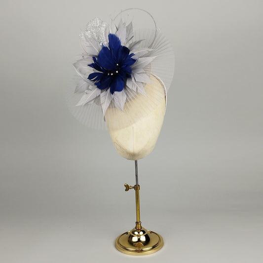 Blue fascinator with grey silver feather petails, pleated crinoline and sparkling accents – delicate and chic silver and Navy fascinator. 