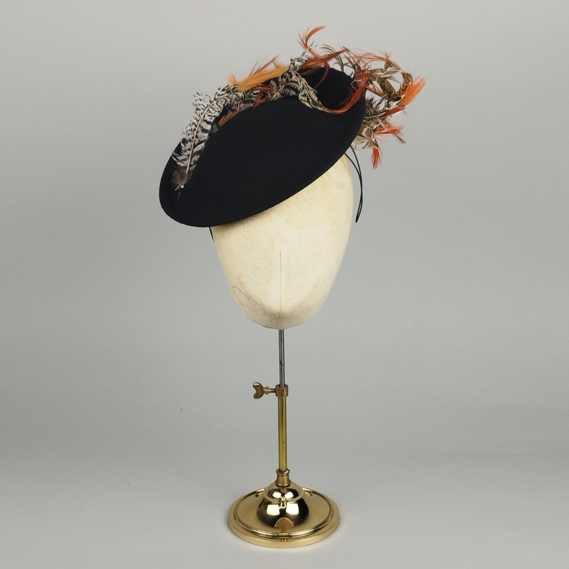 Black winter hatinator with curved pheasant feather detail