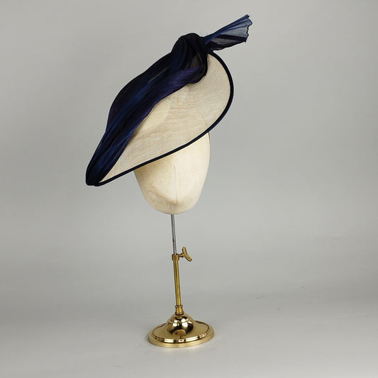 Navy hatinator with flowing ribbons and neutral base, perfect for weddings and Royal Ascot.