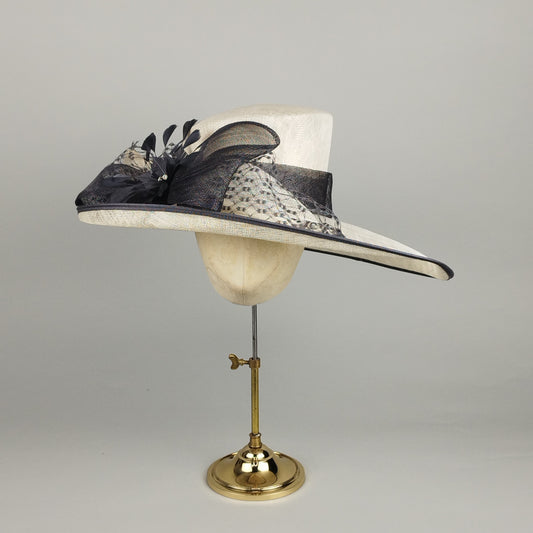 Grey and cream occasion hat with grey net and feather flower. Hat for hire.