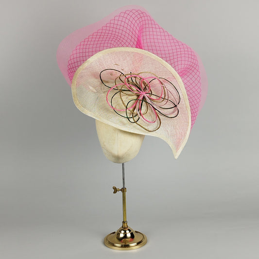 Multicoloured large fascinator with diamond crinoline spray, mounted on a neutral teardrop base. Bold and fun statement piece.