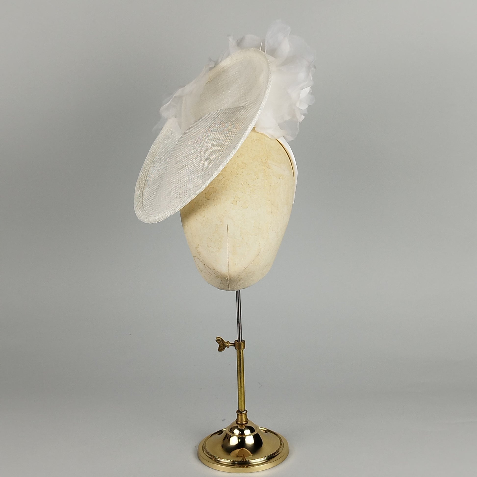 White saucer fascinator with two large silk and organza flowers. Elegant and romantic for weddings and special occasions.